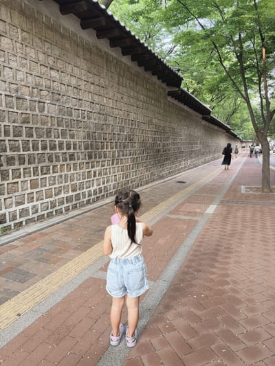 My daughter at the Deoksugung wall, Jeongdong