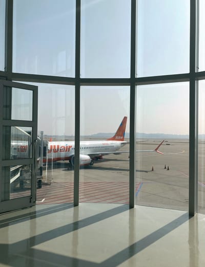 A plane at the gate at Incheon, seen through the terminal glass
