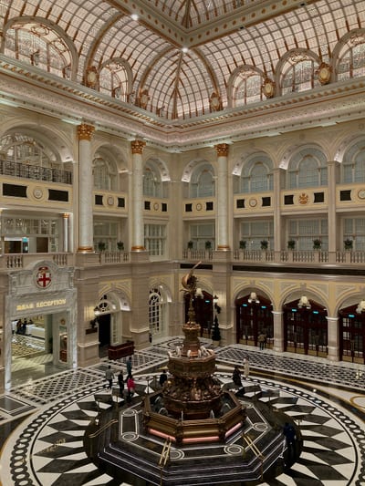 A domed hotel lobby with a bronze fountain at its centre
