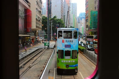 Another tram on the track ahead, seen past the pink window frame of this one